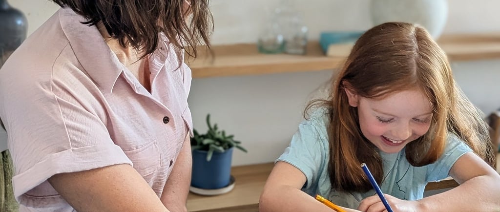 A mother helping her young daughter with 11+ preparation work trying to get ready for the test.