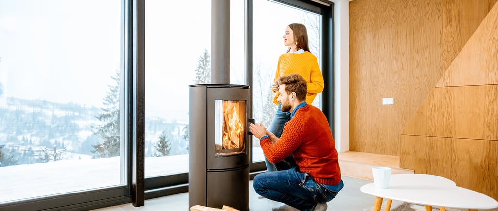 a man and woman sitting on a chair in a living room
