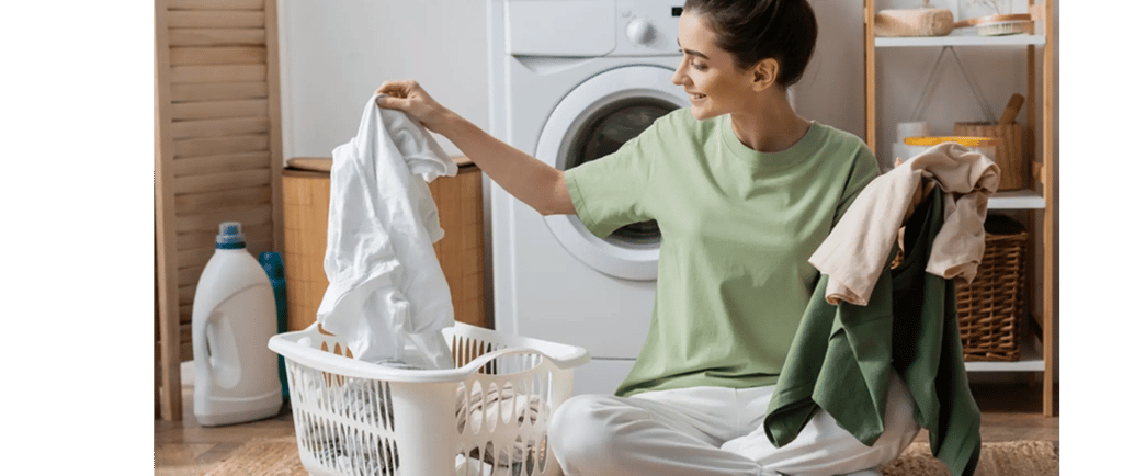 a woman sitting on the floor in front of a washing machine