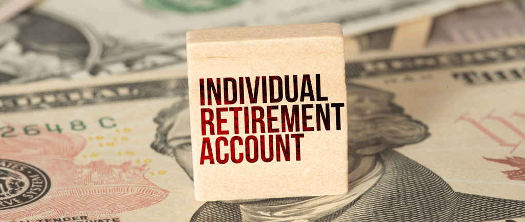 individual retirement account label on a block with money in the background