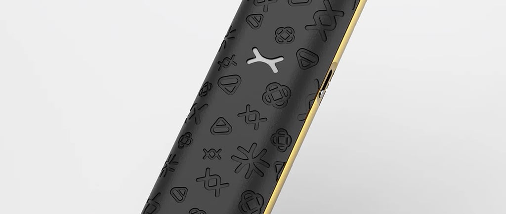 Sleek black and gold pod system vape pen with embossed patterns and a clear mouthpiece.