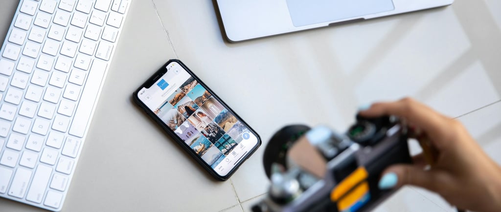 Keyboard, laptop, phone and somebody taking a photo of the phone