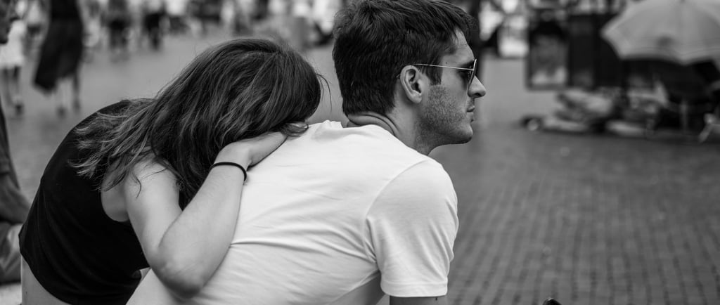 A man ignoring his girlfriend and her affection