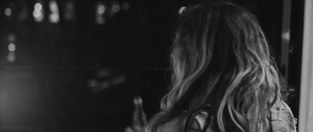 A woman looking out of the window thinking about her ex and wondering if she should reach out to him