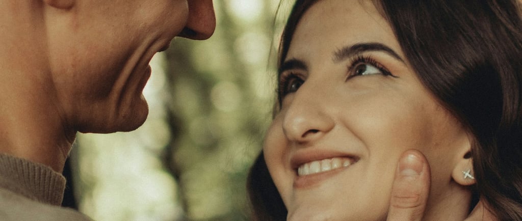 woman smiling softly looking at man who is looking at her with love