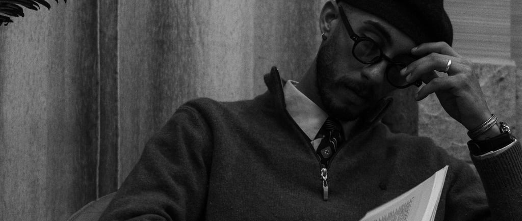 a stressed out man who is quietly reading his book to escape the realities of life