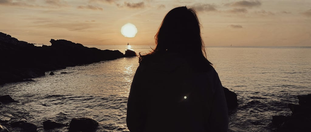 Woman looking out to sea and wondering if her ex misses her.