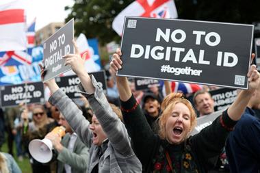 A group of people demonstrating and holding up banners saying no to digital i.d. #together