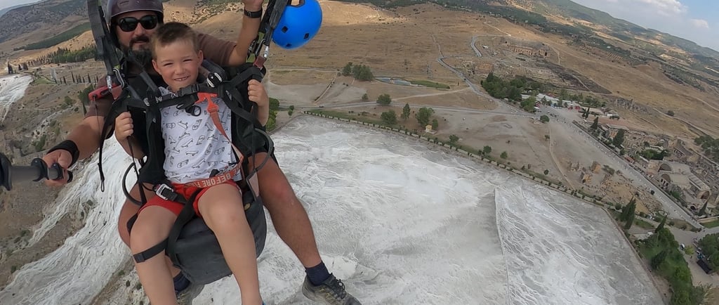 paragliding child over pamukkale