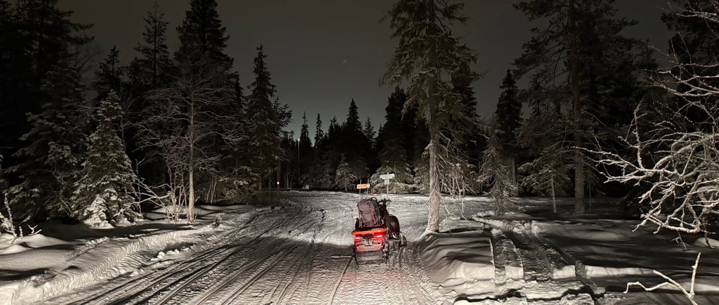 Snow mobiles in the night sky in Ruka Finland 