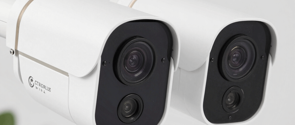 a group of three cameras sitting on top of a table