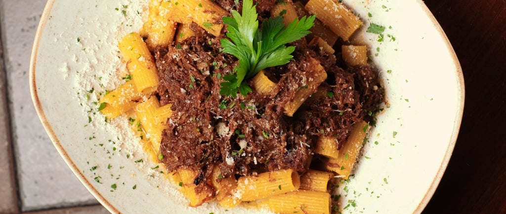 a bowl of pasta with meat and vegetables