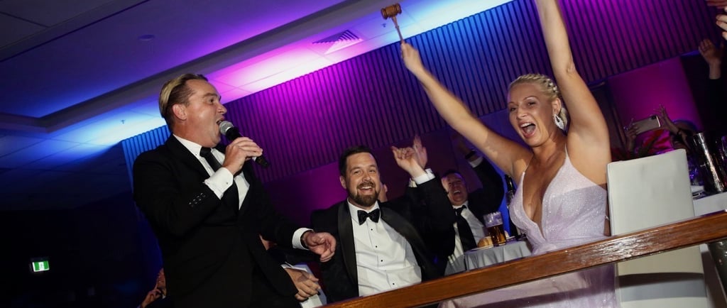 Professional benefit auctioneer Craig directing a high-stakes live auction at a Nashville luxury gal