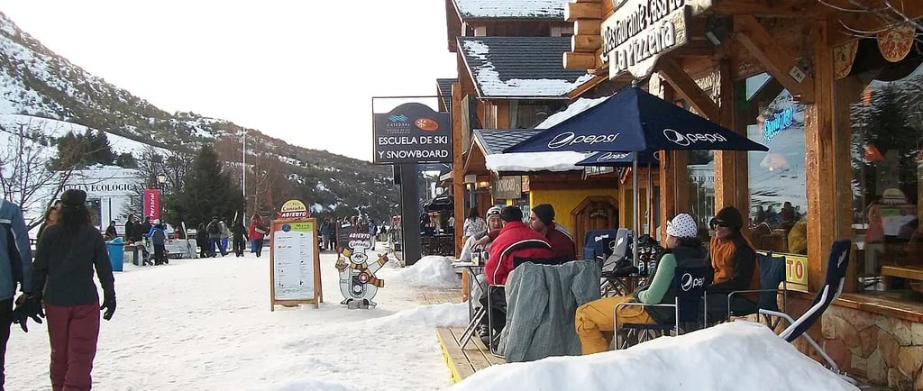 a group of people standing outside a building cerro catedral bariloche argentina