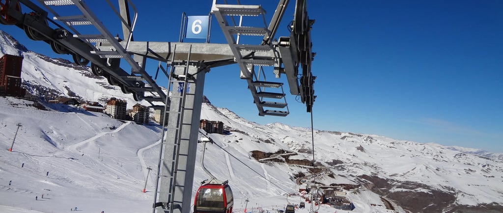 a ski lift going up a mountain with people on it valle nevado chile