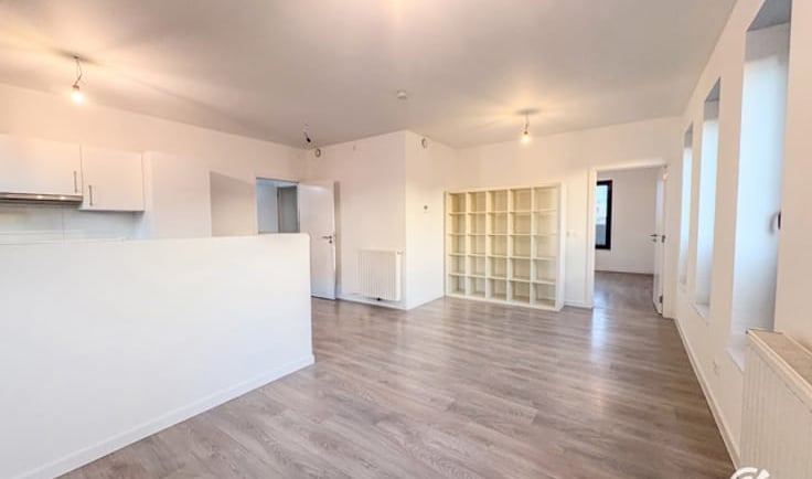 a living room with a large open kitchen and a dining room