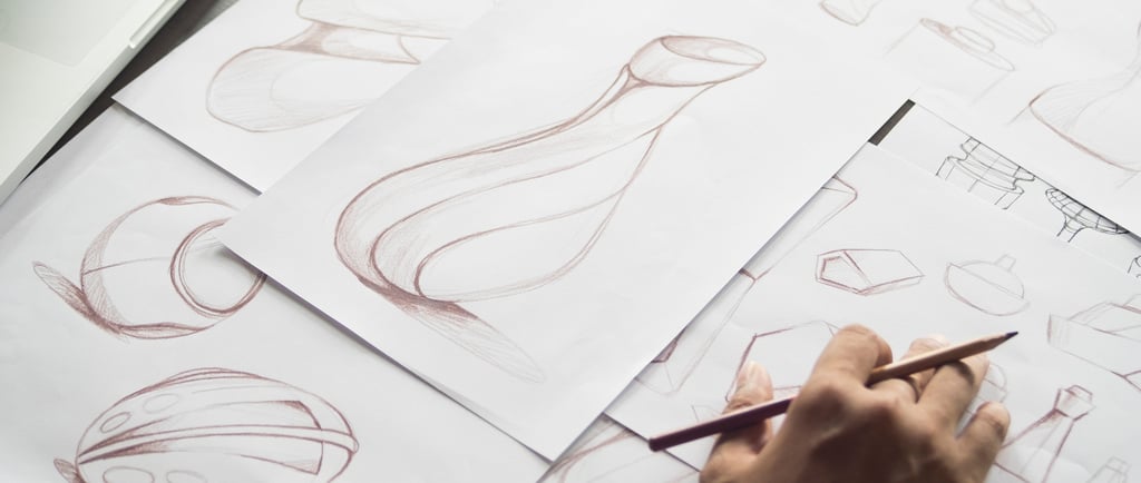 Inventor reviewing product sketches and technical drawings to determine patent eligibility
