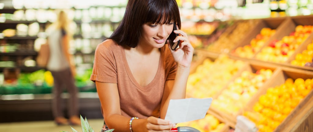 a woman in a grocery store with a shopping carton