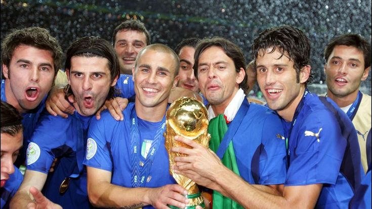 Italian soccer players Fabio Cannavaro and teammates celebrate holding the FIFA World Cup trophy.