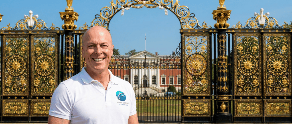 James Oswald Coaching stood in front f Warrington's Golden Gates