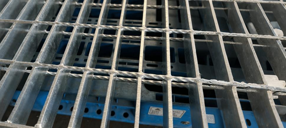 a metal grate with a metal grate and a blue and white background