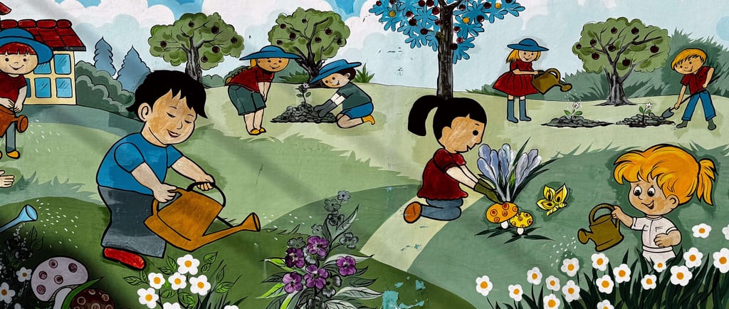 Colorful mural of children in a garden at a Vietnamese kindergarten