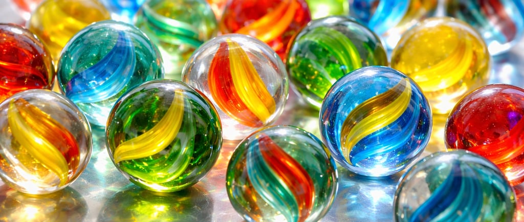 Brightly colored glass marbles on a shiny surface