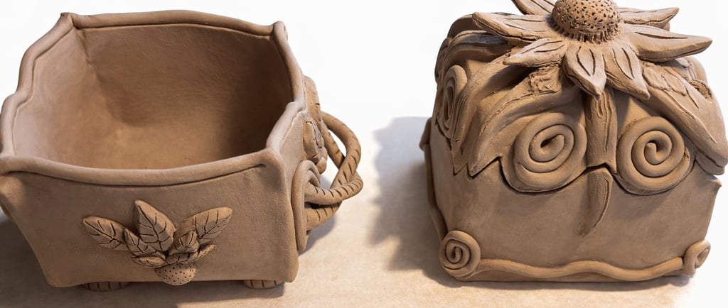 Habd-built pottery box with flower lid