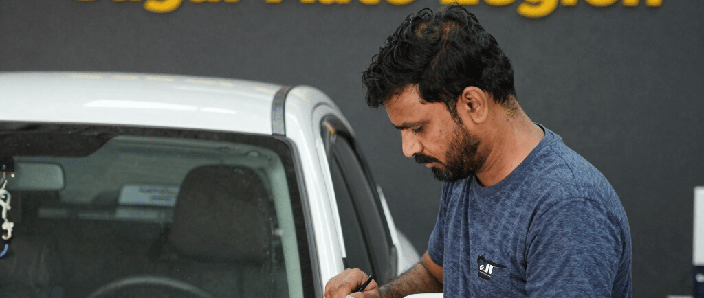 A brown car is parked in front of car care.