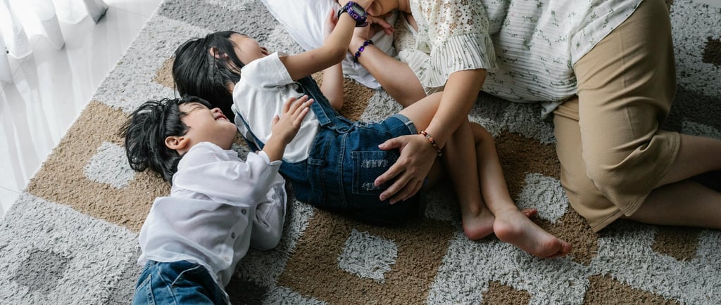 a mom and two children playing together