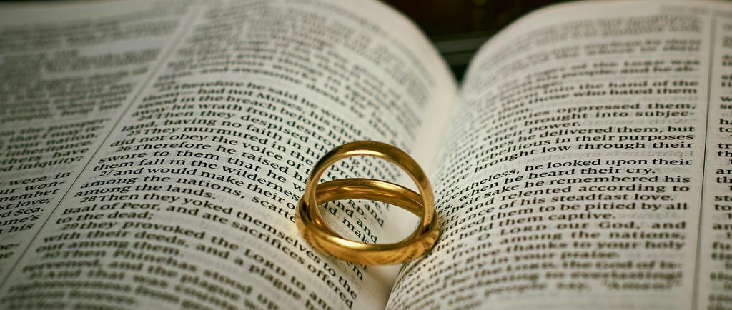 wedding rings of a married couple on a bible