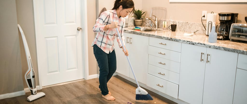 homemaker sweeping the floor