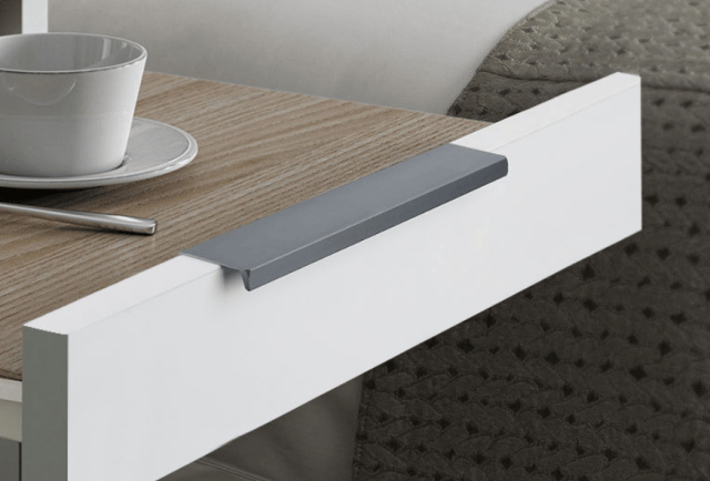 Sleek grey flush cabinet handle installed on a white furniture drawer – minimalist hardware for kitchen, bedroom