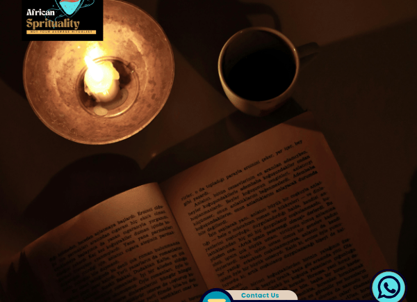 An open book illuminated by a warm candle next to a cup of coffee for a spiritual ritual.
