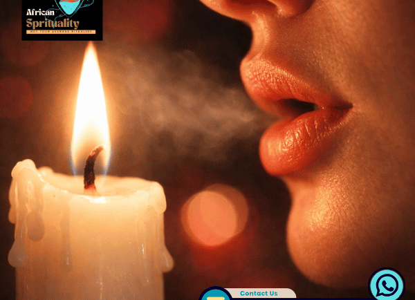A person blowing out a glowing candle flame for spiritual rituals and manifesting intentions.