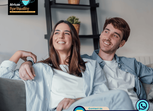 A happy couple sitting on a sofa with African Spirituality branding and contact information.