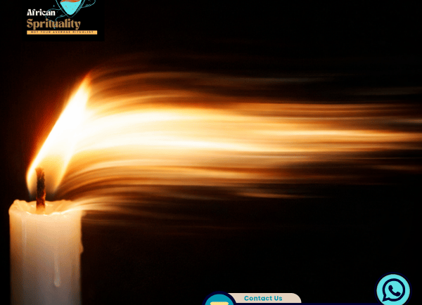 A lit white candle with a long golden flame for African spirituality rituals and healing.