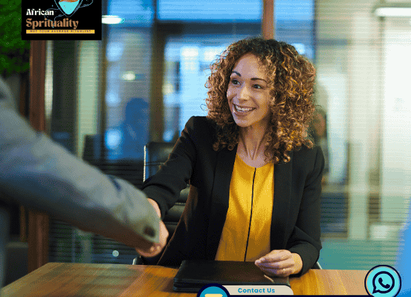 A smiling woman shaking hands in a business meeting for African Spirituality ritual services.