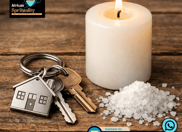 Spiritual house cleansing ritual with a white candle, keys, and sea salt on a wooden table.