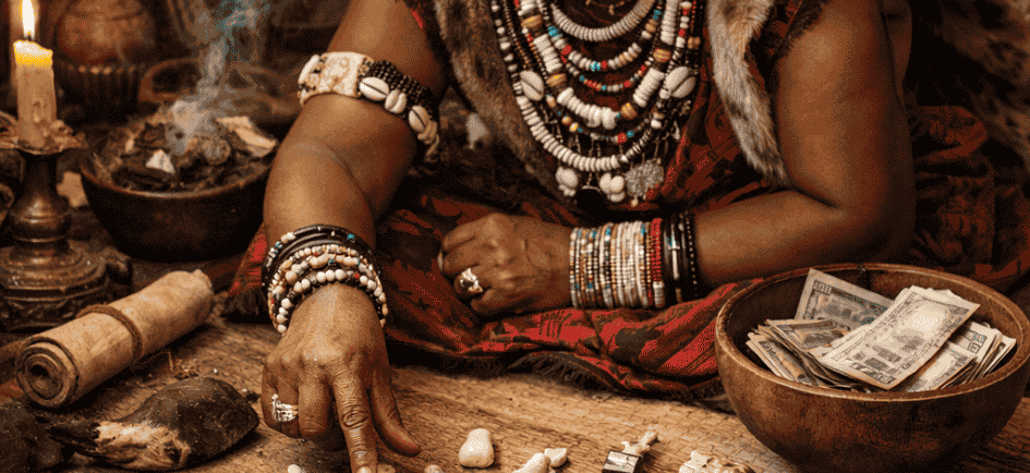 A traditional healer performing an ula (bone) reading focused on career alignment and financial succ