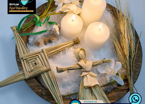 Imbolc altar display with white candles, a straw Brigid's cross, and corn doll on white salt.