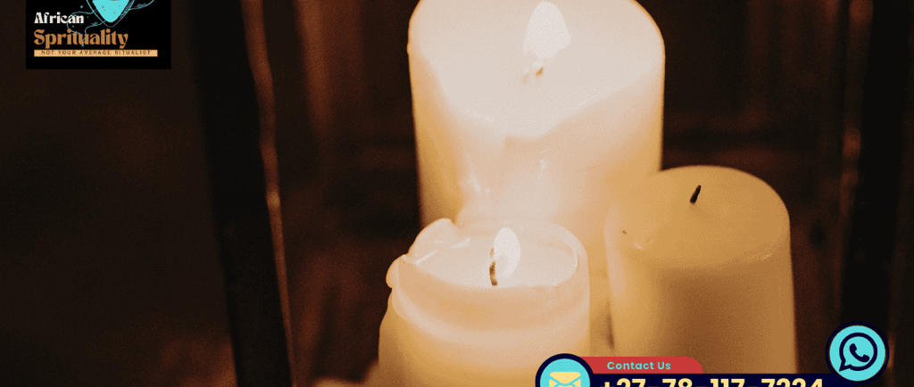 Three white glowing candles lit for an African spirituality ritual and healing ceremony.