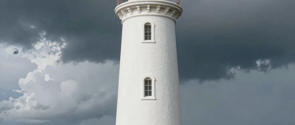 White coastal lighthouse with a red door stands against a dramatic dark storm cloud sky by the ocean.