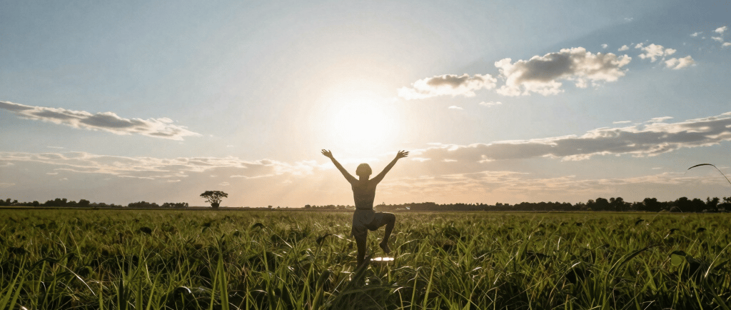A person celebrating under the clearing sky in a lush green field, symbolizing spiritual growth and lucidity.
