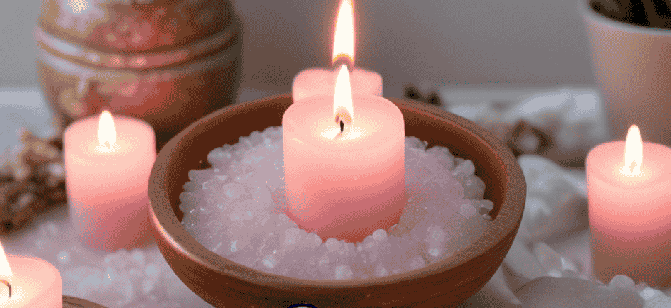 Glowing pink candles and ritual salt for African spirituality cleansing and healing ceremonies.