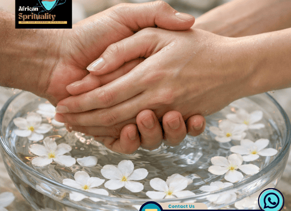 Healing hands holding over water with white flowers for African spirituality rituals and cleansing.