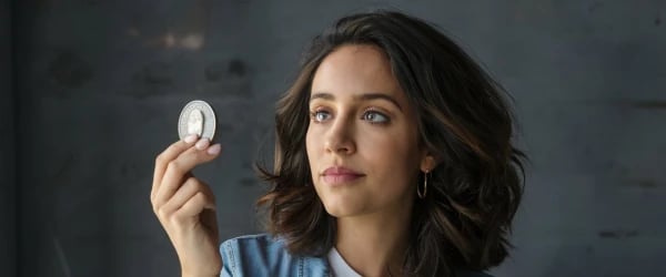 A Woman Trying to Identify a Coin
