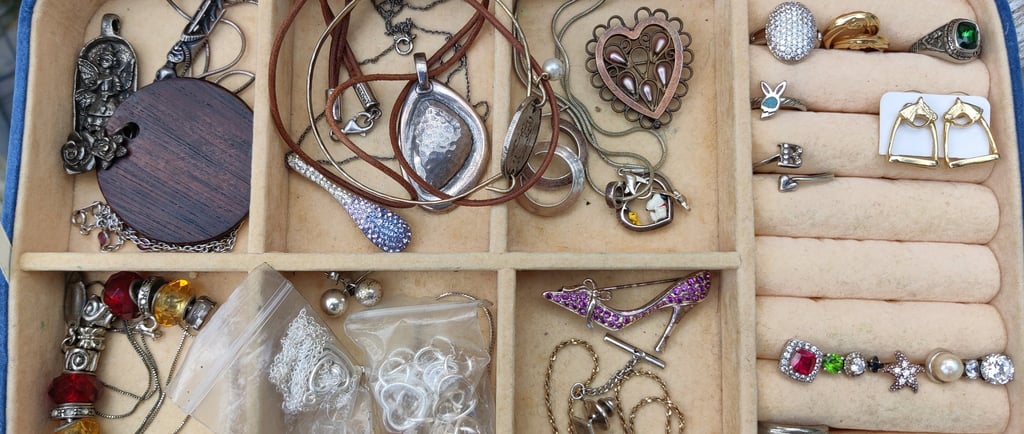 Tray of thrift store vintage gold and silver jewelry.