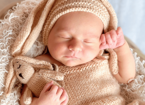 a baby laying in basket