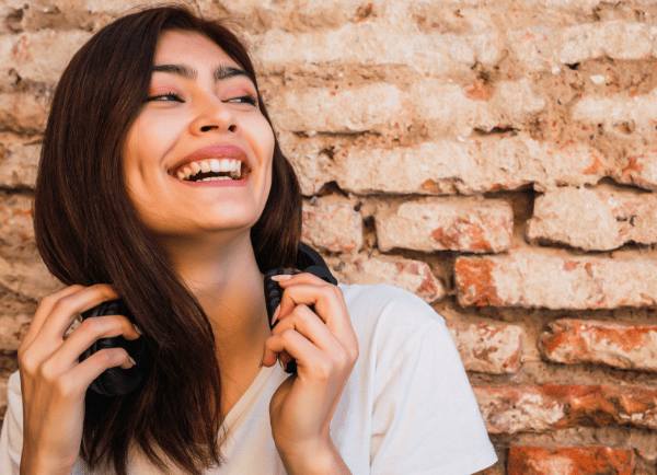 a girl standing and smiling.